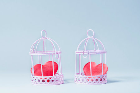 Two red hearts in pink cells. They stand nearby. Blue background.の写真素材