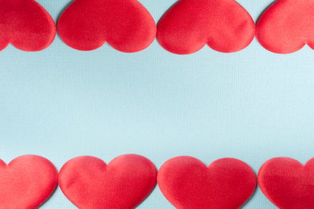 Hearts on a blue background. The hearts form a kind of frame.の写真素材