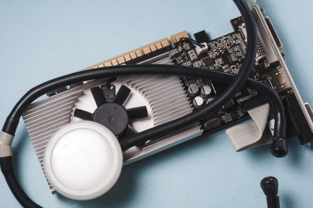 The concept of the workshop of computer technology. The medical stethoscope is on the video card.
