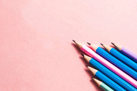 Colorful pencils on a pastel pink background.の写真素材
