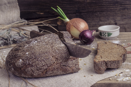 Freshly baked rye bread on rustic backgroundの写真素材