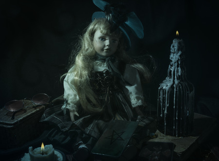 Creepy demonnic doll in the darkの写真素材