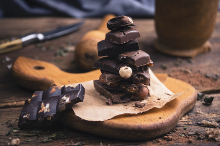 Pieces of chocolate on rustic backgroundの写真素材