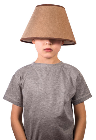 Cute boy with a lampshade on his head on white backgroundの写真素材