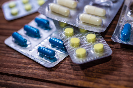 Various pills on the wooden table