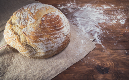 Freshly home baked bread on wooden backgroundの写真素材