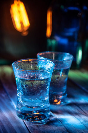 Two shots of vodka in the multiple bar lightsの写真素材