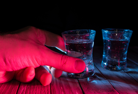 Two shots of vodka in the multiple bar lightsの写真素材