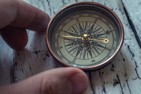 Old vintage compass on rustic wooden backgroundの写真素材