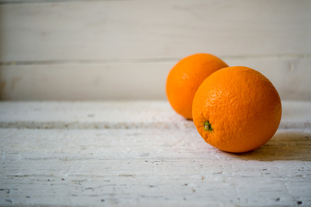 Two oranges on rustic wooden backgroundの写真素材