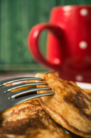 Fresh homemade pancakes with liquid honey and maple syrup, closeup toned photoの写真素材