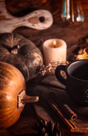 Autumn still life, pumpkins, light bulb and dry leaves on rustic backgroundの写真素材