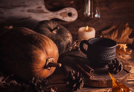 Autumn still life, pumpkins and dry leaves on rustic backgroundの写真素材