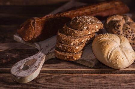 Various homemade bread on rural wooden backgroundの写真素材