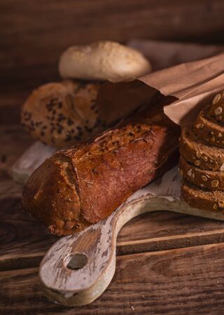Various homemade bread on rural wooden backgroundの写真素材