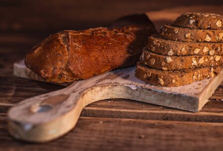 Various homemade bread on rural wooden backgroundの写真素材
