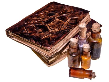 Old magical books and pharmacy bottles isolated on white backgroundの写真素材