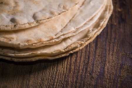Pitta bread on rural wooden backgroundの写真素材