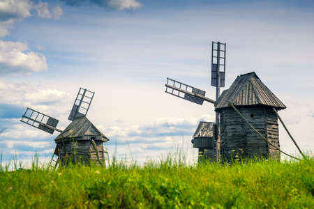 Rural idyllic landscape with wooden windmillsの写真素材