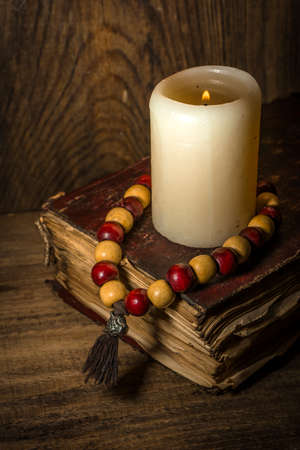 Spiritual still life, old book and wooden beadsの写真素材
