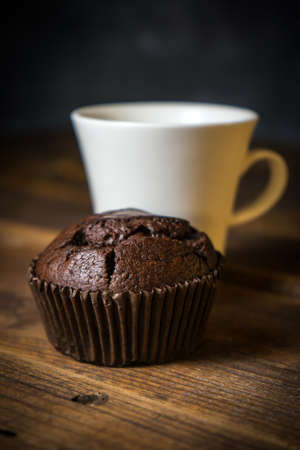 Chocolate muffin on wooden background, morning still lifeの写真素材