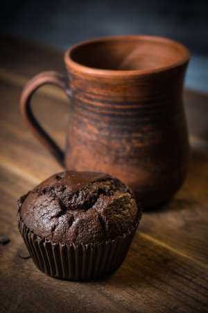 Chocolate muffin on wooden background, morning still lifeの写真素材