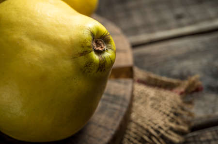Fresh yellow quinces on rural wooden backgroundの写真素材