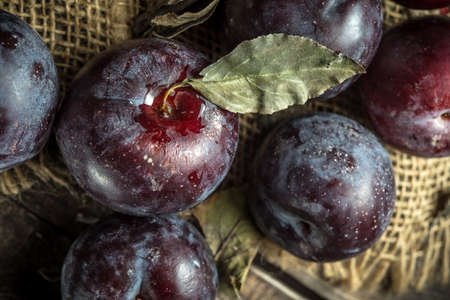 Autumn plums on wooden background, rural still lifeの写真素材