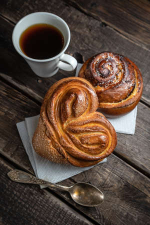 Morning still life of hot fresh home baked buns and coffeeの写真素材