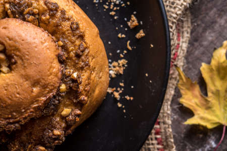 Autumn still life, fresh baked bun on wooden backgroundの写真素材