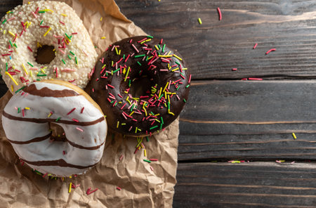 Various fresh baked donuts on a wooden backgroundの写真素材
