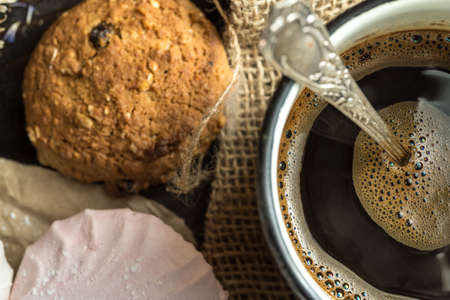 Homemade zephyr, cookies and a cup of coffee on wooden rustic background