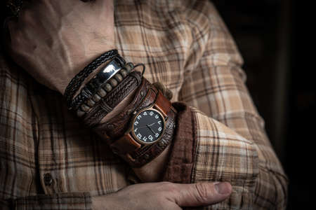 Stylish man wears wrist wooden and leather braceletsの写真素材