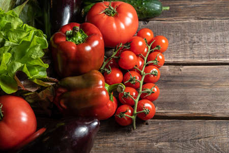 Multiple fresh organic vegetables on a wooden backgroundの写真素材