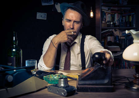 Retro private detective behind the desk, noir cinematic sceneの写真素材