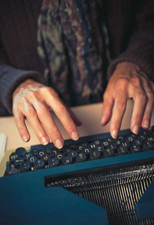 intage female writer reporter working behind her deskの写真素材