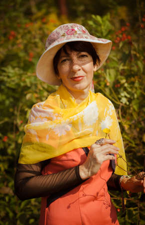 Lady in orange enjoying the parkの写真素材