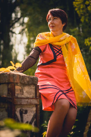 Lady in orange enjoying the parkの写真素材