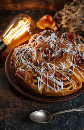Freshly baked sweet buns on black board on grey stone backgroundの写真素材