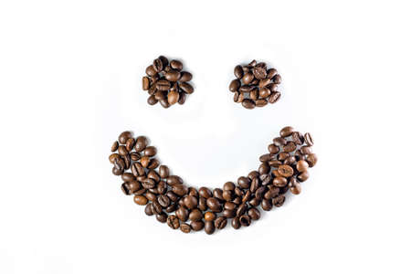 Smiley face made of coffee beans on white backgroundの写真素材