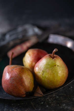Autumn pears on the dark rustic backgroundの写真素材