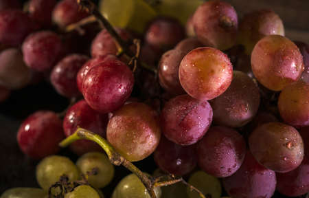 Fresh red and green organic grapes on wooden table, selective focusの写真素材