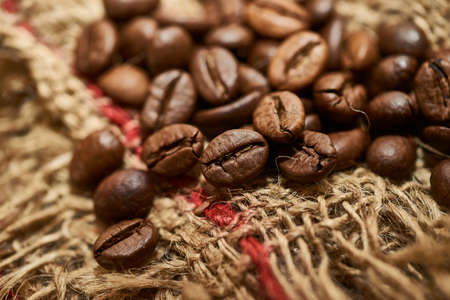 Roasted coffee beans on a piece of sackclothの写真素材
