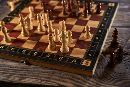 Chess figures on chessboard on retro background, Queen gambit, one man army