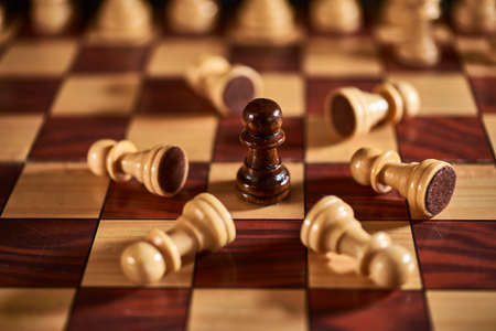 Chess figures on chessboard on retro background, Queen gambit, one man armyの写真素材