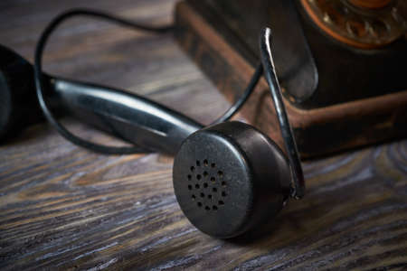 Classic telephone vintage color, dialing or scrolling phone on wooden tableの写真素材
