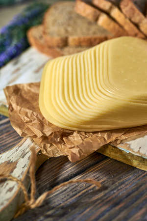 Sliced pieces of cheese on rustic wooden background, cheese sandwichesの写真素材