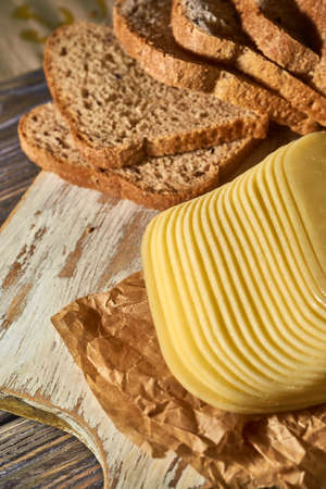 Sliced pieces of cheese on rustic wooden background, cheese sandwichesの写真素材