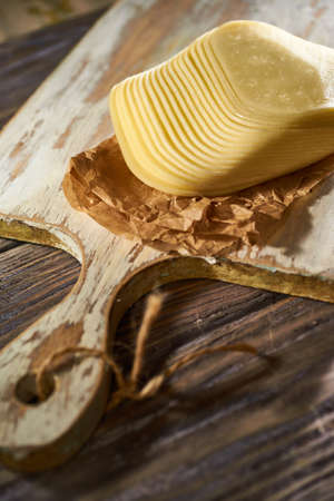 Sliced pieces of cheese on rustic wooden background, cheese sandwichesの写真素材