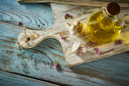 A bottle of organic olive oil on a rustic backgroundの写真素材